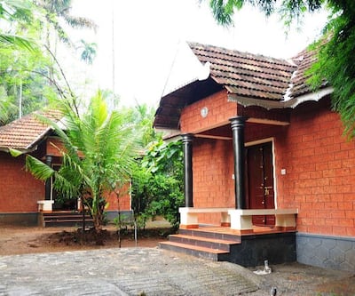 https://imgcld.yatra.com/ytimages/image/upload/t_hotel_yatra_city_desktop/v1435233381/Domestic Hotels/Hotels_Thrissur/Rayirath Heritage/COTTAGE  VIEW.jpg